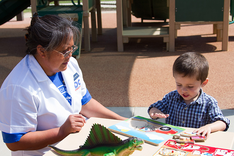 toddler playing with caregiver