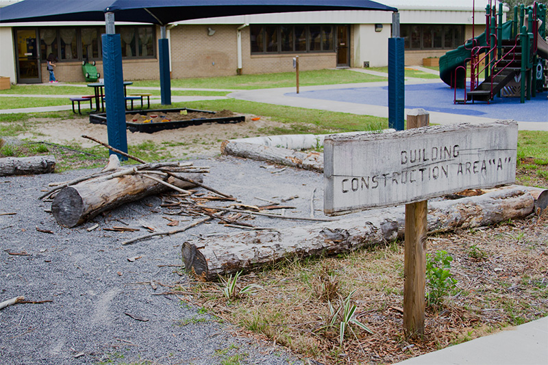 An outdoor space with a sign reading 