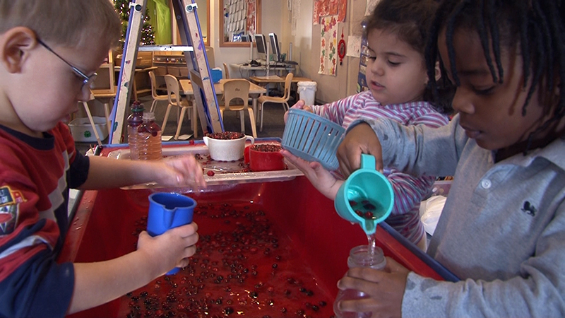 Children playing with cups and water